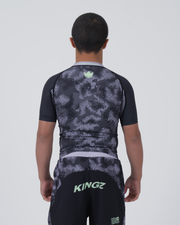 Kingz Viper Youth Rashguard Black Purple - Full Body Back View Teen Boy Athlete Short Sleeve Hexagonal Pattern Green Crown Logo Upper Back KINGZ Green Text Shorts Purple Waistband Kids