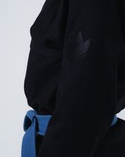 Kingz Born to Rule Women's Jiu Jitsu Gi Black - Close-Up Detail View Black Crown Badge Quilted Shoulder Blue Belt Contrast BJJ Gi Training [color:Black]