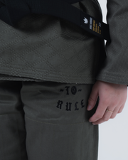 Kingz Born to Rule Women's Jiu Jitsu Gi Military Green - Close-Up Detail View Black Embroidered Text "TO RULE" Diamond Weave Pattern Black Belt Crown Badge BJJ Gi Training Apparel [color:Military Green]