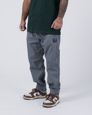 Kingz Casual Rip Stop Gi Pant Grey - Front View Male Athlete Grey Rip Stop Fabric Black Patch Logo Elastic Cuffs Relaxed Fit BJJ Gi Training Apparel [color:Grey]