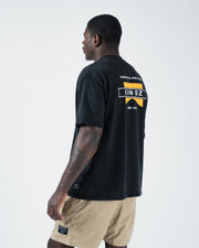 Kingz Flag Tee - Side Back View - KINGZ Flag Back Graphic Visible - Black Pigment Dye BJJ T-Shirt