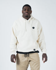 Beige BJJ pullover hoodie front view on adult male model with dark crown chest logo and box fit
