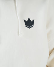 Beige BJJ hoodie chest closeup of dark navy crown emblem logo and drawstring hood cord on soft fleece