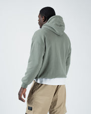 Dark forest green BJJ hoodie back three-quarter view on adult male model showing clean rear panel drape