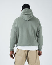 Dark forest green BJJ hoodie back view on adult male model displaying full rear panel and drawstring hood