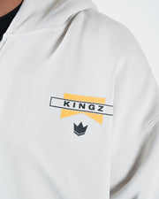 Grey BJJ zip up hoodie chest closeup of Kingz flag banner logo and crown emblem screen print detail