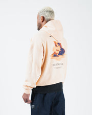 Peach BJJ hoodie rear side profile on adult male model showing angled Jiu Jitsu Motion back graphic