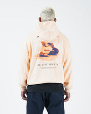 Peach BJJ hoodie back view on adult male model displaying full centered Jiu Jitsu Motion graphic print