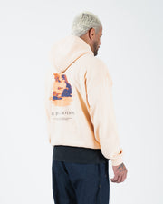 Peach BJJ hoodie rear three-quarter view on adult male model highlighting motion back print and hood