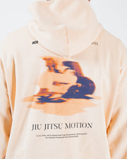 Peach BJJ hoodie back graphic closeup detail of blurred motion artwork and Jiu Jitsu Motion lettering