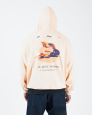 Peach BJJ hoodie full body back lifestyle shot with adult male model showing complete motion graphic print