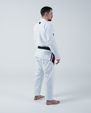 Kingz Ultralight 2.0 BJJ Gi White - 3/4 Angled Back View Male Athlete Wearing White Gi Red Crown Logo Sleeve Patches Black Belt Barefoot