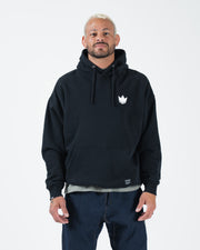 Black BJJ pullover hoodie front view on adult male model with white crown chest logo and box fit
