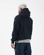 Black BJJ hoodie back three-quarter view on adult male model showing clean rear panel and hood drape