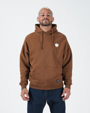 Chestnut brown BJJ pullover hoodie front view on adult male model with white crown chest logo and box fit