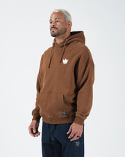Chestnut brown BJJ hoodie front three-quarter view on adult male model showing crown logo and box cut