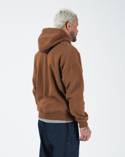 Chestnut brown BJJ hoodie rear side profile on adult male model showing relaxed drape and hood detail