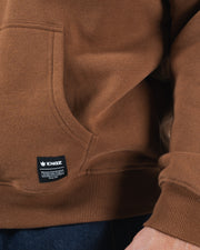 Chestnut brown BJJ hoodie bottom hem closeup of woven Kingz crown label tag pocket and ribbed hem detail