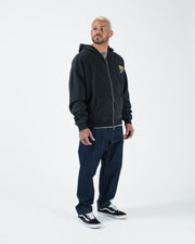 Black BJJ zip up hoodie full length angled front shot with adult male model in dark denim streetwear