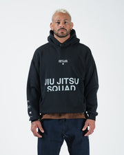 Black BJJ pullover hoodie front view on adult male model showing Jiu Jitsu Squad chest print and pocket