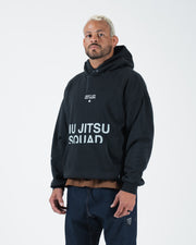 Black BJJ hoodie side angle on adult male model highlighting Jiu Jitsu Squad print and relaxed fit