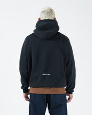 Black BJJ hoodie rear view on adult male model displaying Gentle Art back text and ribbed cuffs