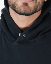 Black BJJ hoodie collar detail closeup showing snap button neckline closure and dual panel construction