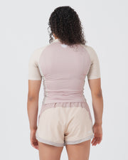 Kingz Terra Women's Rashguard Soil Edition - Full Body Straight Back View Female Athlete Short Sleeve Dusty Rose Mauve Body Cream Beige Raglan Sleeves White Crown Logo Center Back Matching Cream Beige Hybrid Shorts Mauve Waistband Women's BJJ No-Gi