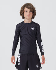 Kingz Kore V2 Youth L/S Rashguard Navy Black - Full Body Front View Teen Boy Athlete Long Sleeve Navy Blue Minimal Design White Crown Logo Circle Chest KINGZ White Sleeve Text Matching Navy Shorts Kids BJJ Training [color:Black]