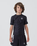 Kingz Kore V2 Youth S/S Rashguard Navy Black - Full Body Front View Teen Boy Athlete Short Sleeve Navy Blue Minimal Design White Crown Logo Circle Chest KINGZ White Sleeve Text Matching Navy Shorts Crown Logo Hem Kids BJJ Training [color:Black]