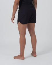 Kingz Kore 2.0 Women's Shorts Black - Full Body Left-Back Side Profile Female Athlete Solid Black All-Black Longer Competition Cut Side Split Visible Women's Grappling Shorts No-Gi BJJ Kore Collection [color:Black]