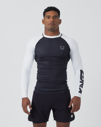 Kingz Ranked Performance V2 L/S Rashguard Navy White - Full Body Front View Male Athlete Long Sleeve Navy Blue Body White Raglan Sleeves White Crown Logo Chest KINGZ White Sleeve Text White Collar Matching Navy Shorts BJJ IBJJF