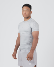 Kingz Ghost Rashguard Silver Gray - Full Body 3/4 Angled Front View Male Athlete Short Sleeve All Gray Minimal Design Compression Fit Crown Badge Shorts Ghost Inspired BJJ Training
