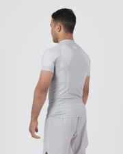 Kingz Ghost Rashguard Silver Gray - Full Body 3/4 Back View Left Side Male Athlete Short Sleeve All Gray Minimal Design Ghost Aesthetic Matching Gray Shorts Compression Fit BJJ