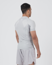 Kingz Ghost Rashguard Silver Gray - Full Body 3/4 Back View Right Side Male Athlete Short Sleeve All Gray Minimal Design Crown Logo Subtle Back Matching Gray Shorts Ghost BJJ Training