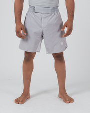 Kingz Ghost Grappling Shorts Silver Gray - Full Body Front View Male Athlete Light Silver Gray Color Small White Crown Logo Right Thigh Gray Waistband Minimal Design Competition Cut Men's Grappling Shorts No-Gi BJJ Ghost Collection