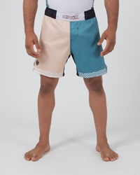 Kingz Flow Performance Series Shorts Blue Cream - Full Body Front View Male Athlete Two-Tone Color Block Cream Beige Left Panel Teal Blue Right Panel Wavy Hem Trim Pattern KINGZ White Box Badge Black Waistband Competition Cut Men's Grappling Shorts No-Gi BJJ