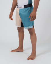 Kingz Flow Performance Series Shorts Blue Cream - Full Body Right Side Profile Male Athlete Two-Tone Color Block Cream Front Teal Blue Side Wavy Hem Trim Side Pocket Detail Competition Cut Men's Grappling Shorts No-Gi BJJ