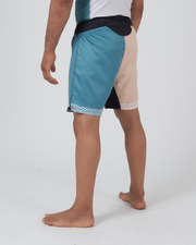 Kingz Flow Performance Series Shorts Blue Cream - Full Body Left-Back Side Profile Male Athlete Teal Blue Front Cream Back Panel Wavy Trim Hem Black Side Panels Competition Cut Men's Grappling Shorts No-Gi BJJ