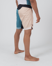 Kingz Flow Performance Series Shorts Blue Cream - Full Body Right-Back Side Profile Male Athlete Teal Blue Front Cream Beige Back Wavy Hem Trim Crown Logo Right Thigh Competition Cut Men's Grappling Shorts No-Gi BJJ
