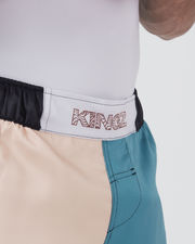 Kingz Flow Performance Series Shorts Blue Cream - Close Up Waistband Detail KINGZ Wavy Pattern Font White Badge White Label Black Elastic Waistband Two-Tone Color Block Cream Teal Visible Side Pocket Stitch Men's Grappling Shorts No-Gi BJJ