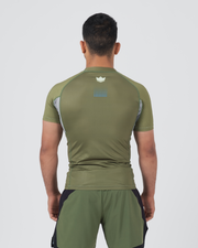 Kingz Trooper Rashguard Military Green - Full Body Straight Back View Male Athlete Short Sleeve Crown Logo Centered Back Blue Dot Pattern Gray Side Panels Olive Green Military Style
