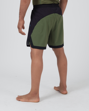Kingz Trooper Hybrid Shorts Black Olive - Full Body Left-Back Side Profile Male Athlete Two-Tone Design Large Olive Green Back Panel Black Front Panel Inner Compression Shorts Olive Hem Visible Men's Grappling Shorts No-Gi BJJ