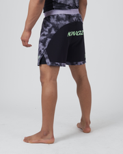 Kingz Viper Hybrid Shorts Black Purple - Full Body Left Side Profile Male Athlete KINGZ Lime Green Text Left Hip Hexagonal Camo Pattern Sublimated Black Side Panels Competition Cut Split Hem Men's Grappling No-Gi BJJ