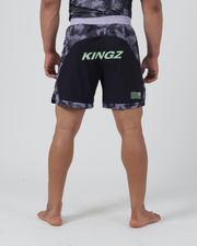 Kingz Viper Hybrid Shorts Black Purple - Full Body Back View Male Athlete KINGZ Large Lime Green Text Back Panel Hexagonal Camo Pattern Upper Solid Black Lower Panels Flag Badge Detail Lavender Waistband Men's Grappling No-Gi BJJ