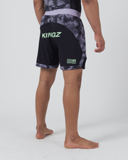 Kingz Viper Hybrid Shorts Black Purple - Full Body Back View Wide Stance Male Athlete KINGZ Lime Green Text Back Panel Hexagonal Camo Pattern Upper Solid Black Lower Panels Flag Badge Right Leg Men's Grappling No-Gi BJJ