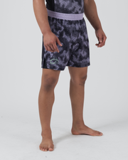 Kingz Viper Hybrid Shorts Black Purple - Full Body Back View Narrow Stance Male Athlete KINGZ Lime Green Text Back Panel Hexagonal Camo Pattern Upper Solid Black Lower Panels Flag Badge Right Leg Men's Grappling No-Gi BJJ
