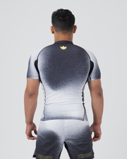 Kingz Galaxy Rash Guard Black White - Full Body Straight Back View Male Athlete Short Sleeve Black Upper Back To White Lower Ombre Galaxy Spatter Pattern Gold Crown Logo Center Back Matching Galaxy Spats Leggings KINGZ Gold Text