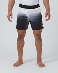 Kingz Galaxy Performance Series Shorts Black White - Full Body Front View Male Athlete Black White Galaxy Fade Gradient Pattern White Top Fading to Black Bottom Gold Crown Logo Right Thigh Black Elastic Waistband Competition Cut Men's Grappling Shorts No-Gi BJJ