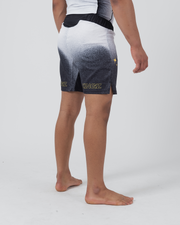 Kingz Galaxy Performance Series Shorts Black White - Full Body Left Side Profile Male Athlete Galaxy Gradient KINGZ Gold Text Gold Star Sparkle Graphic Left Leg Side Split Competition Cut Men's Grappling Shorts No-Gi BJJ